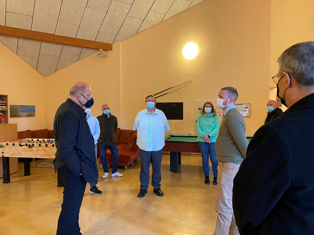 Der Landrat steht mit mehreren Menschen im Jugendclub.