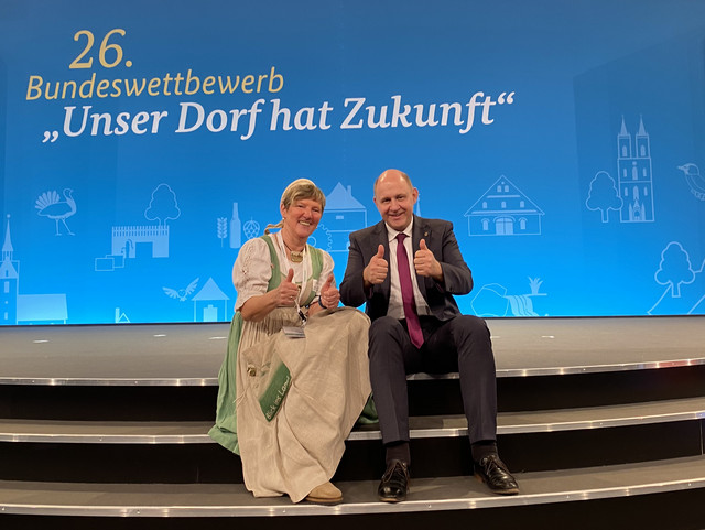 Gudrun Lewwe und Landrat Roger Lewandowski lächeln in die Kamera und zeigen ihre nach oben ausgestreckten Daumen.