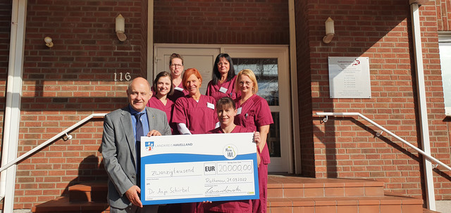 Klick öffnet Bildbetrachter, eine Gruppe von Menschen vor einem Gebäudeeingang