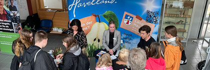 Klick öffnet Nachricht, an zwei Informationstischen stehen zahlreiche junge Menschen