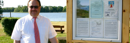 Amtsarzt Dr. Erich Hedtke mit der Hinweistafel am Hohennauener See.