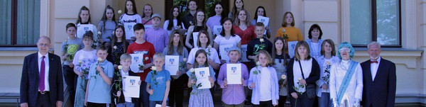 Eine größere Gruppe steht auf einer Trepppe.