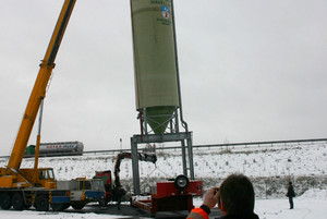 Der erste von zwei Silos wird vom Schwerlasttransport aufgehoben und an seinen endgültigen Standort gehievt.