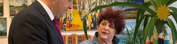 Zwei Personen stehen in einem Atelier und unterhalten sich - Klick öffnet Bildbetrachter