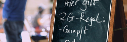 Ein Aufsteller mit der Aufschrift "Hier gilt 2G-Regel: geimpft oder genesen".